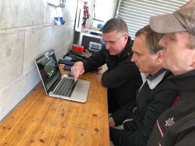 Drivers reviewing video footage on laptop